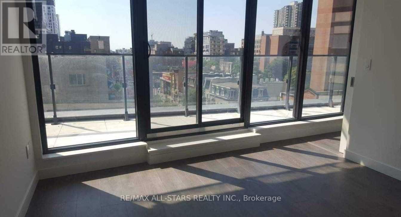 A room with a view of the city through large windows.