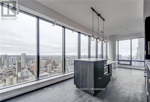 A spacious room with large windows overlooking a cityscape.