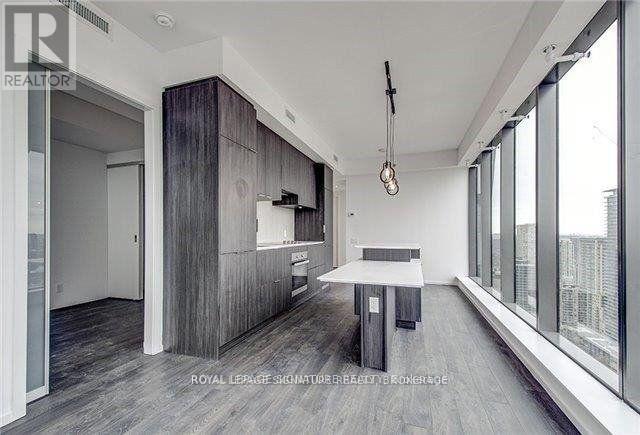 A modern kitchen with a dining table and chairs.