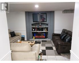 A living room with a fireplace and a television.