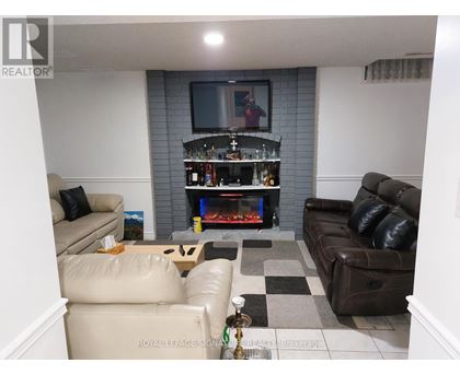 A living room with a fireplace and a television.