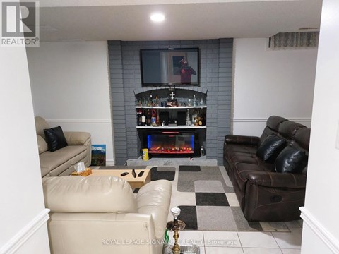 A living room with a fireplace and a television.