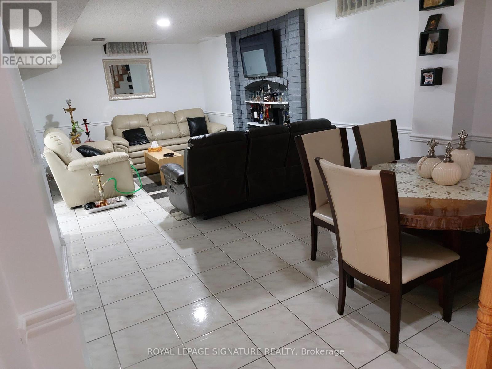 A living room with a black couch and a white sofa.