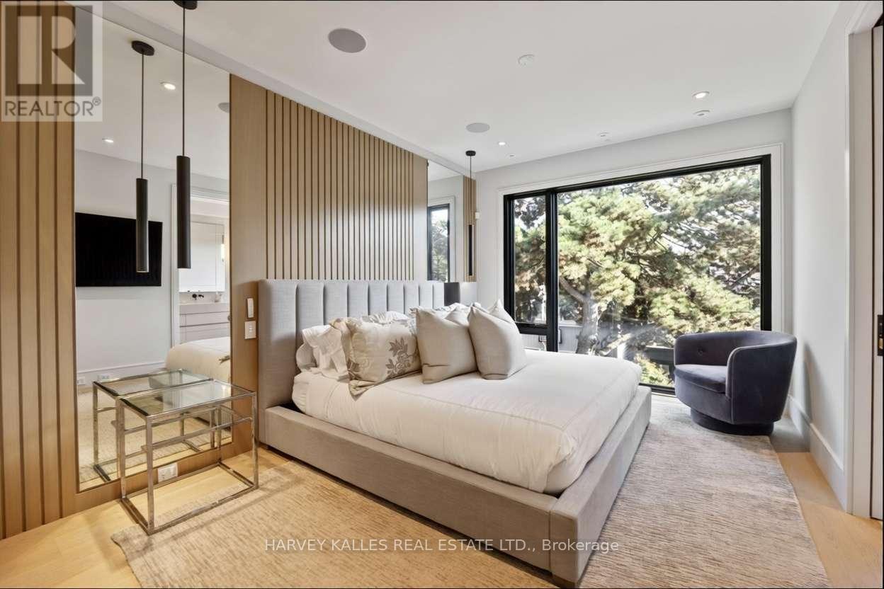 A bedroom with a large bed and a glass table.