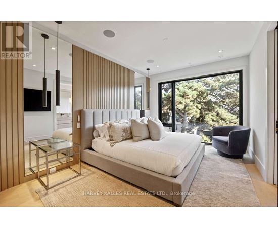A bedroom with a large bed and a glass table.
