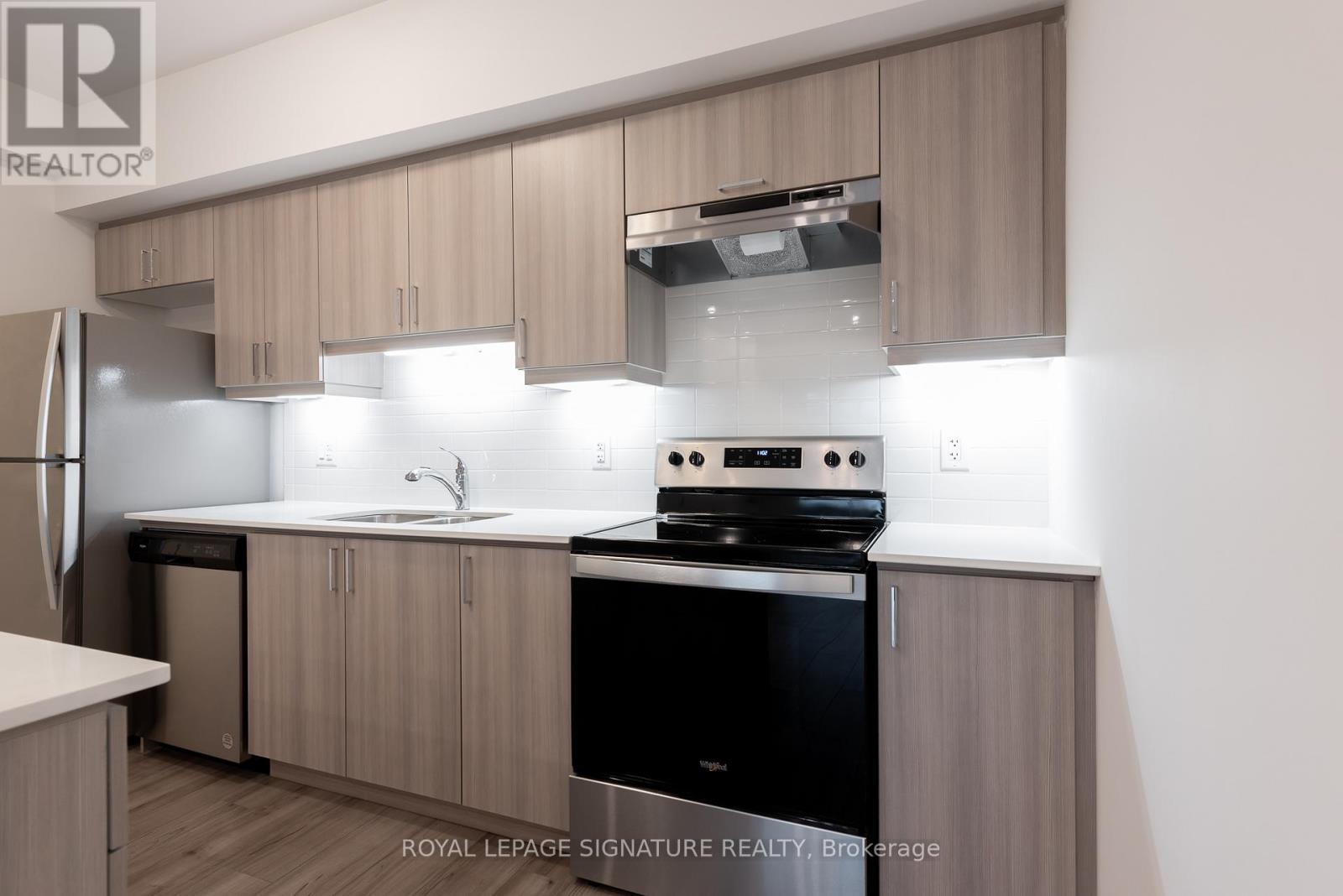 A modern kitchen with wooden cabinets and stainless steel appliances.