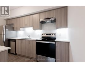 A modern kitchen with wooden cabinets and stainless steel appliances.
