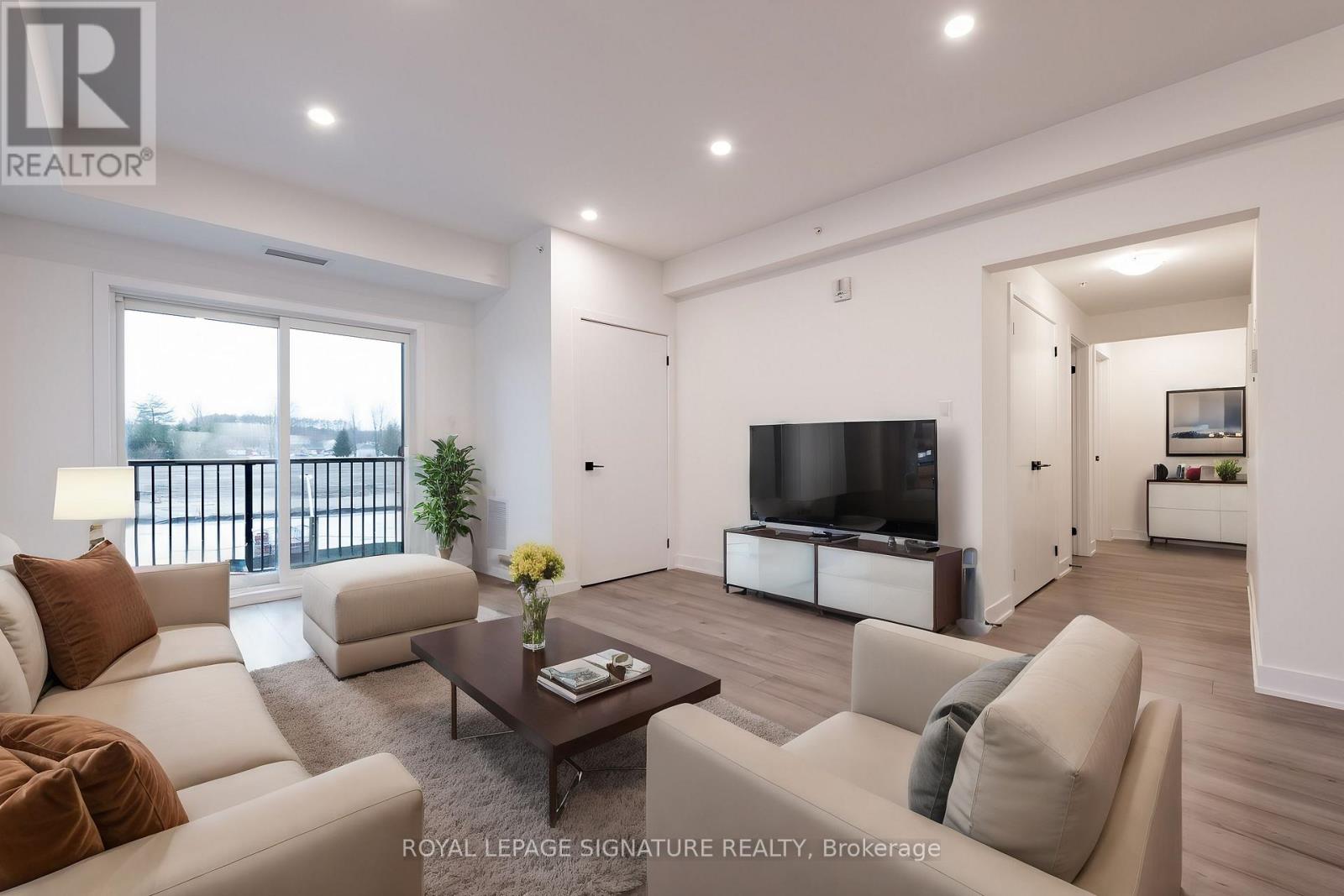A living room with a white couch and a television.