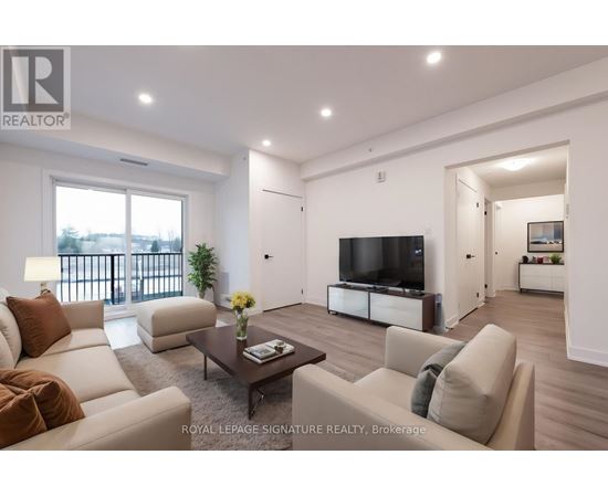 A living room with a white couch and a television.