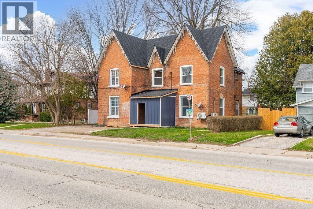 A red brick house with a black garage door.