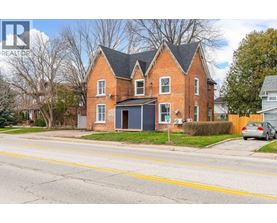 A red brick house with a black garage door.