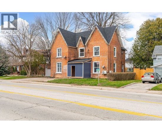 A red brick house with a black garage door.