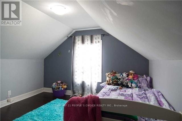 A bedroom with a bed and a window with curtains.