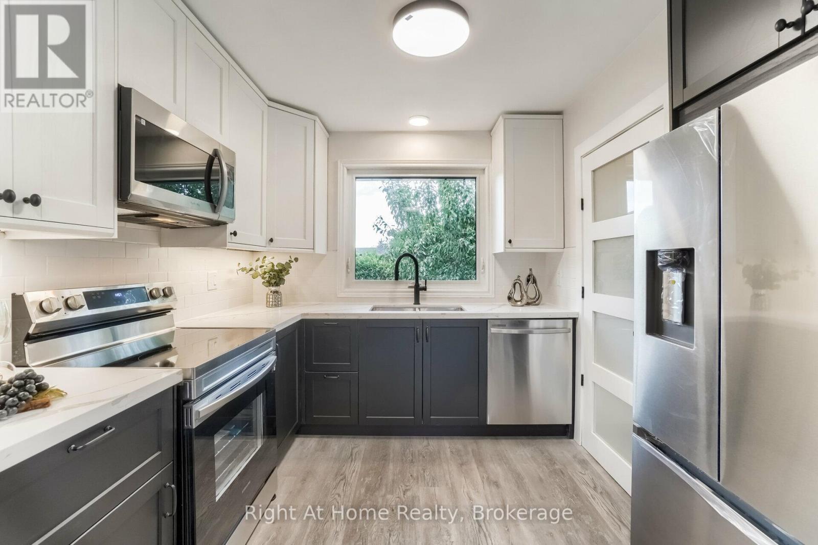 A kitchen with a stove top oven and a refrigerator.