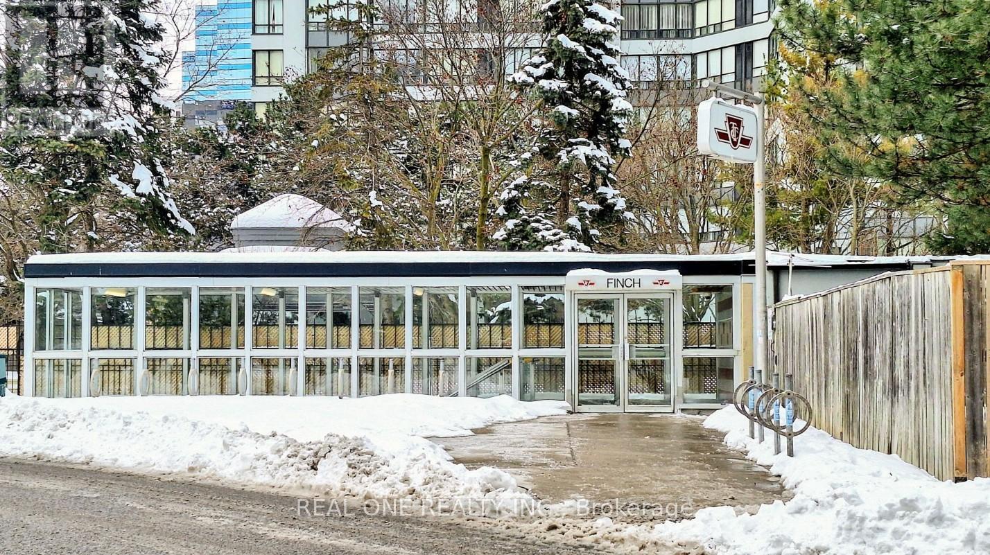 A building with a glass facade and a white roof is surrounded by snow.