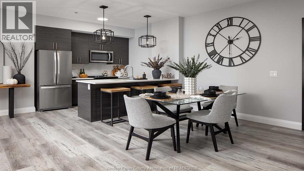 A modern kitchen with a dining table set for two.