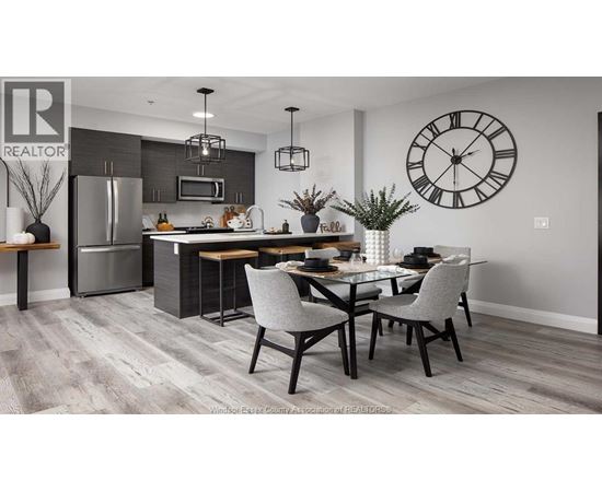 A modern kitchen with a dining table set for two.