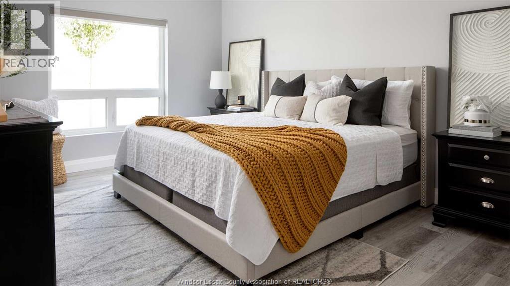 A bedroom with a large bed and a window.
