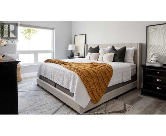 A bedroom with a large bed and a window.
