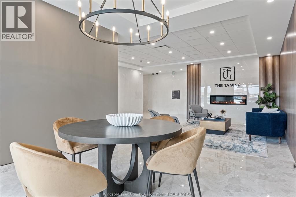 A modern dining room with a round table and chairs.