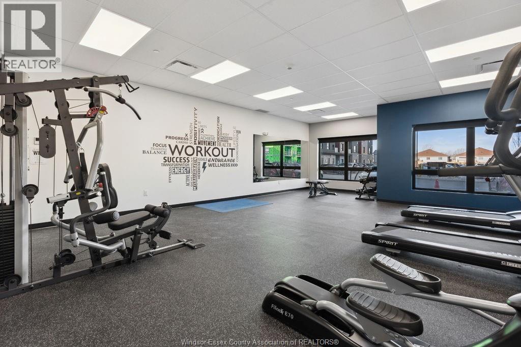 A gym with treadmills, weights and a wall that says "Workout Success".