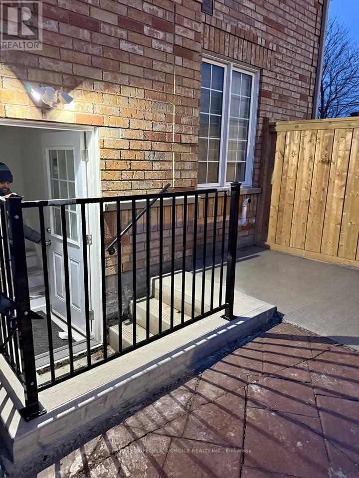 A black metal railing on a brick wall.