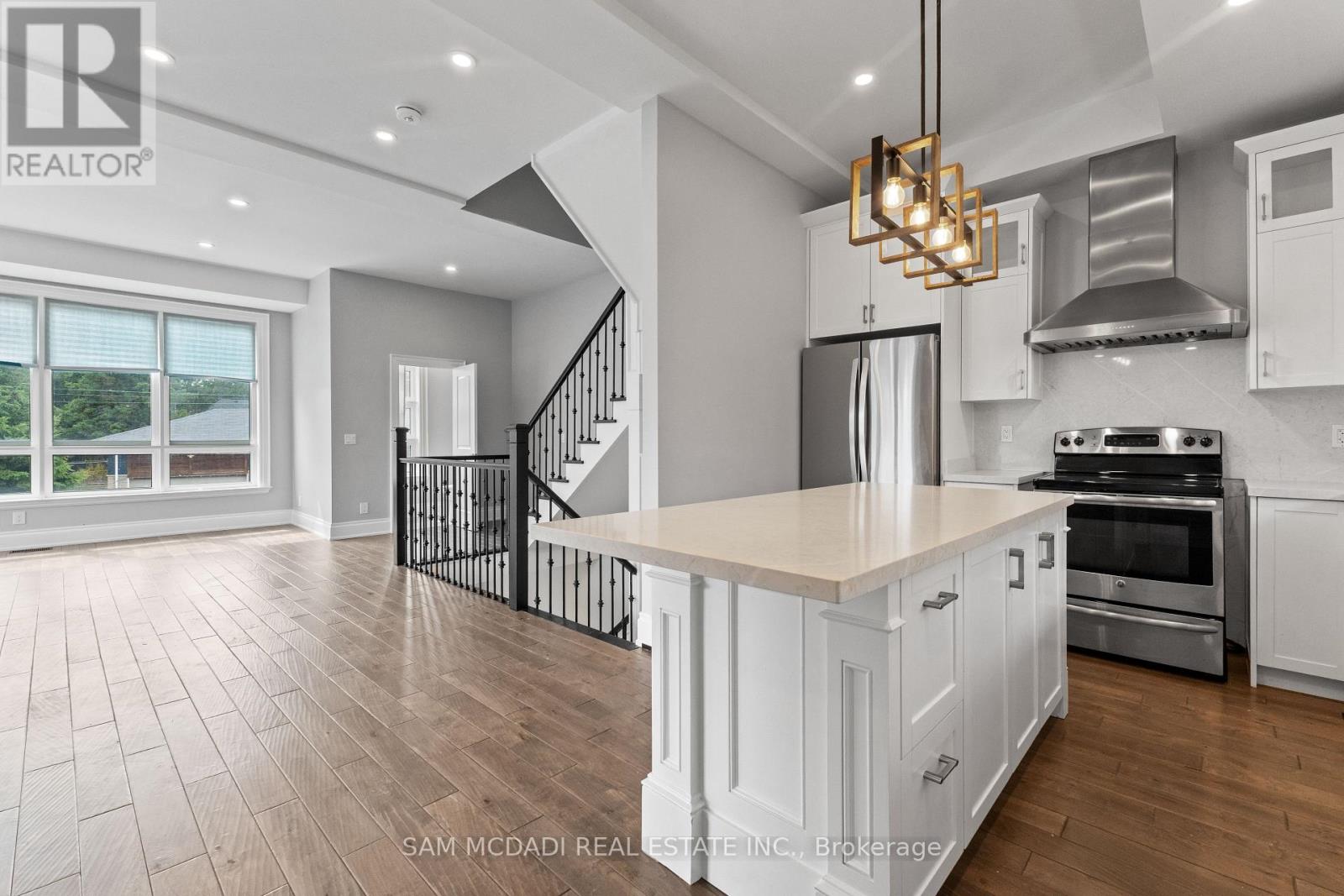 A modern kitchen with white cabinets and a center island.