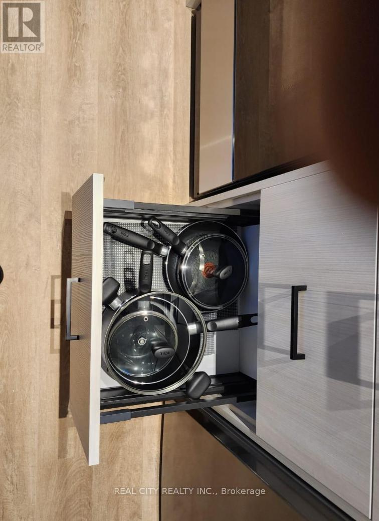 A stainless steel pot sits on a stove in a modern kitchen.