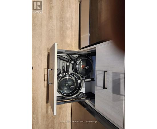 A stainless steel pot sits on a stove in a modern kitchen.