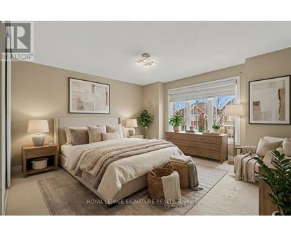 A bedroom with a large bed and a window overlooking a street.