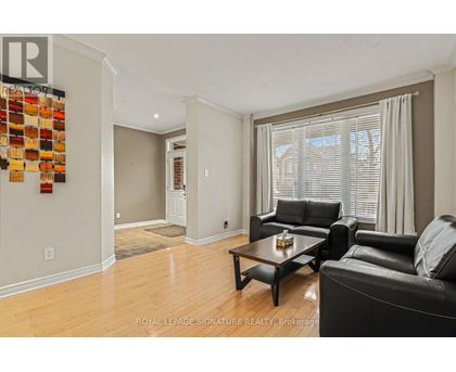 A living room with a black leather couch and a wooden coffee table.