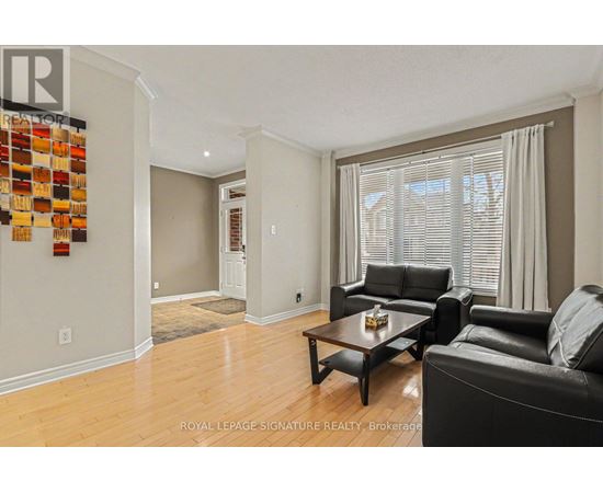 A living room with a black leather couch and a wooden coffee table.