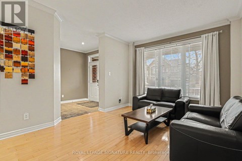 A living room with a black leather couch and a wooden coffee table.