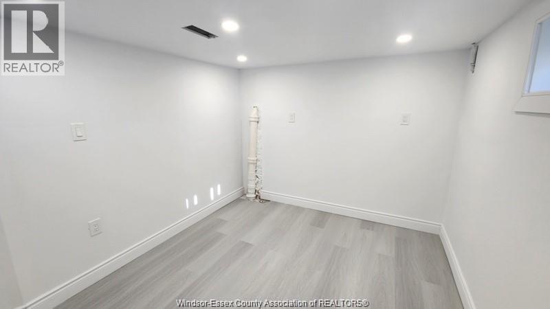 A room with white walls and a wooden floor.