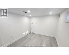 A room with white walls and a wooden floor.
