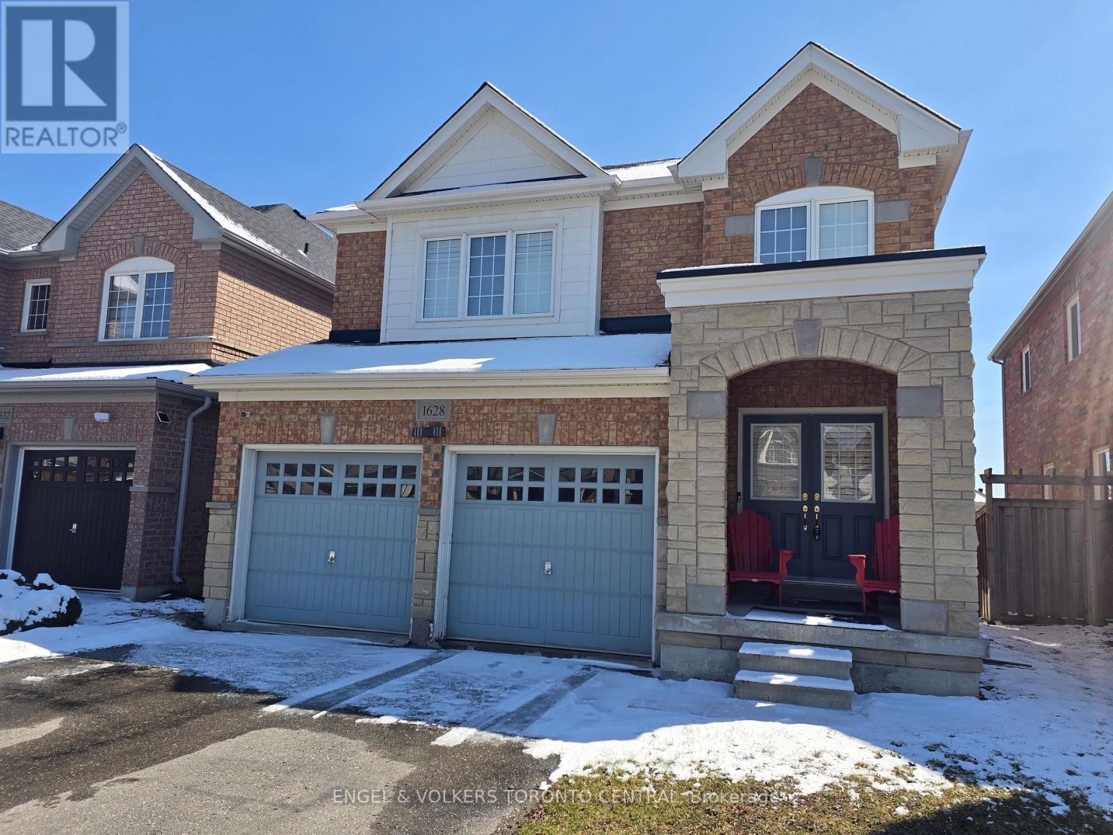 A house with a red door and a garage is shown in the image.