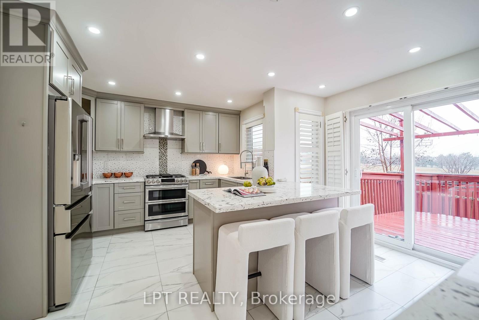 A modern kitchen with white cabinets and a large island.