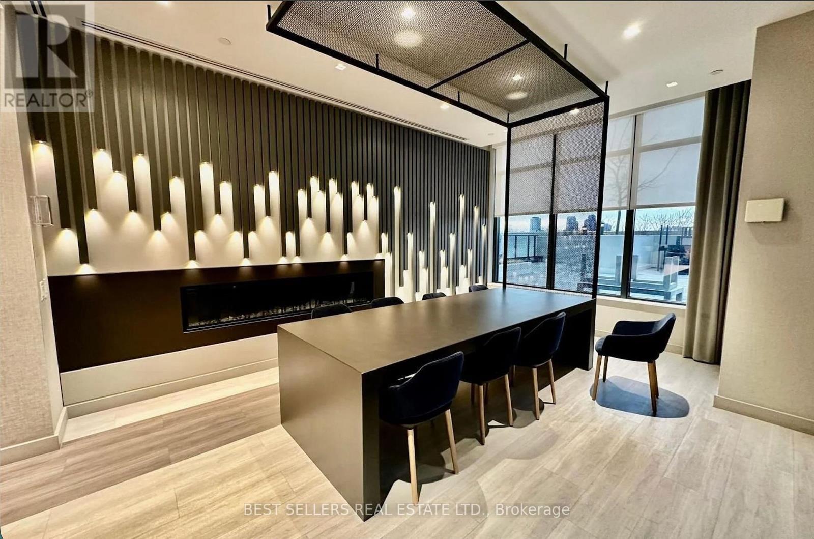 A modern office space with a long table and chairs.