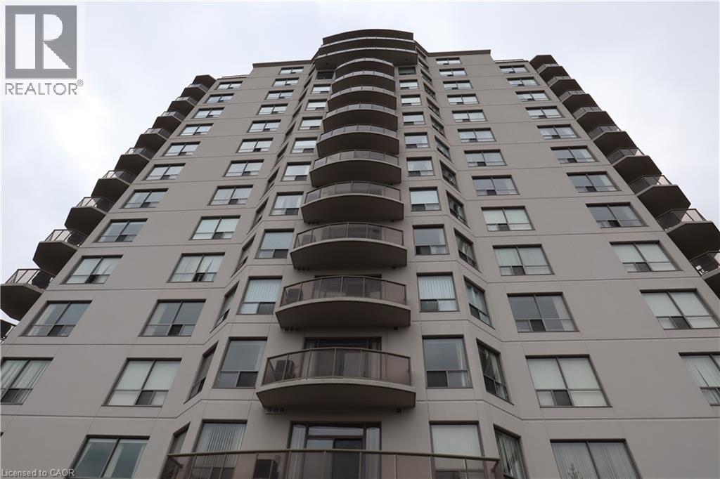 A tall residential building with balconies on the upper floors.