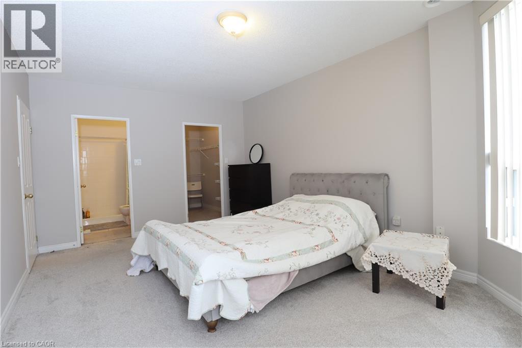 A bedroom with a large bed and a window.