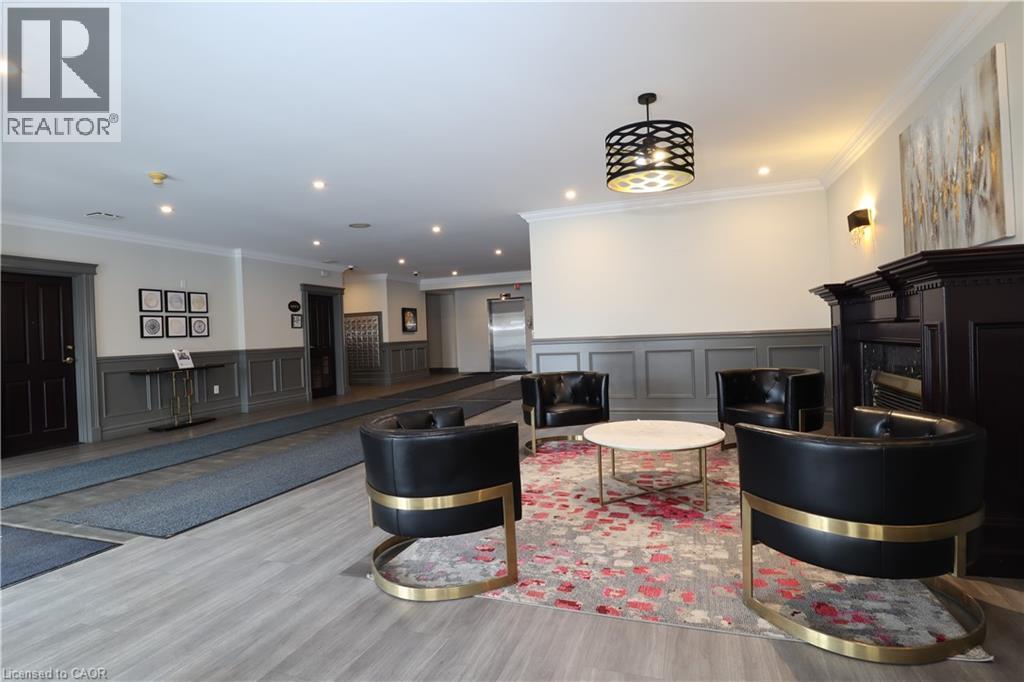A living room with a black and gold chair and a fireplace.