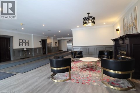 A living room with a black and gold chair and a fireplace.