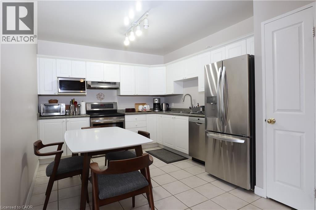 A kitchen with a table and chairs.