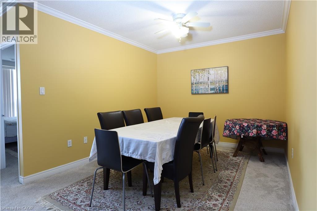 A dining room with a table and chairs.