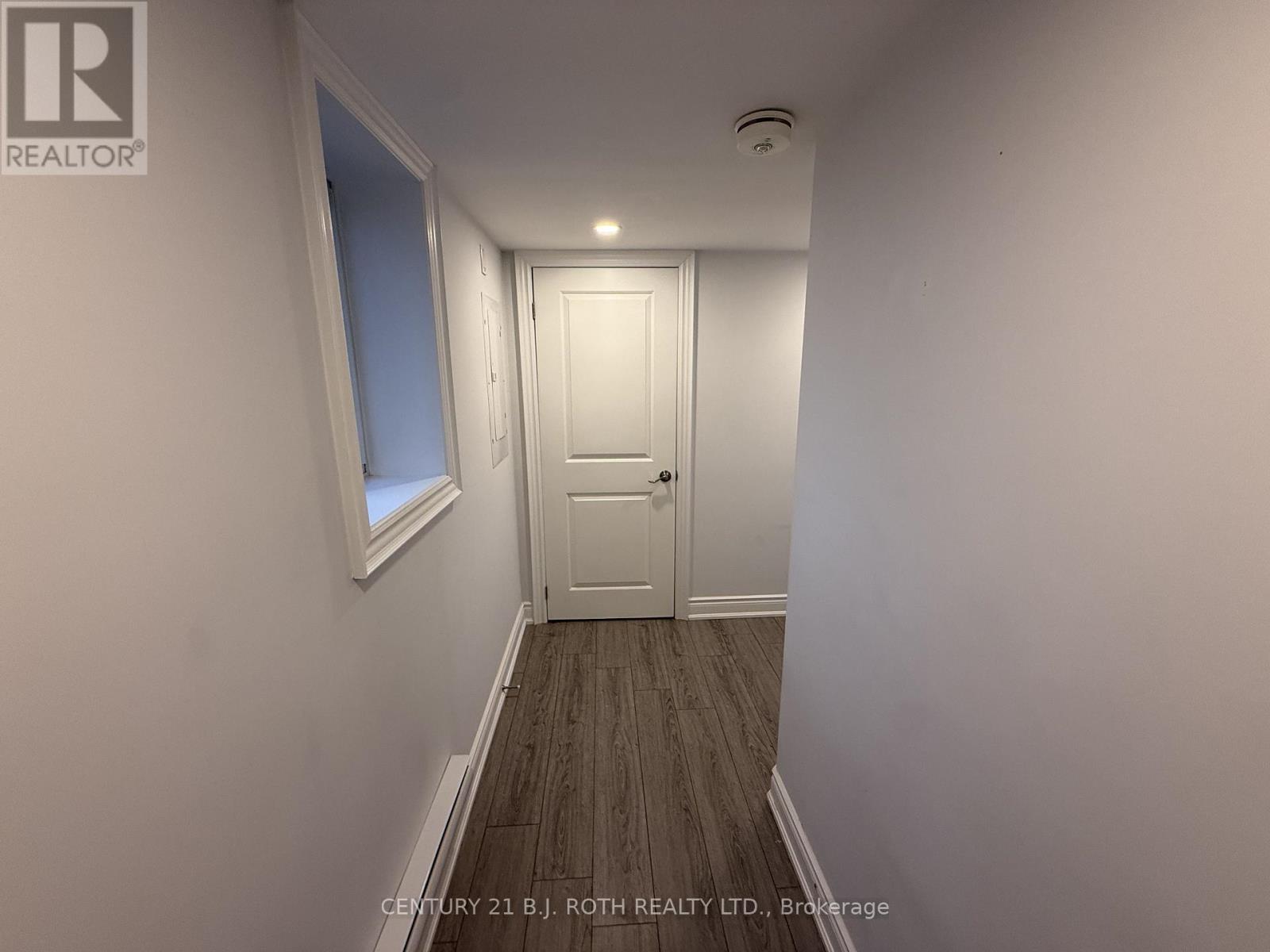 A hallway with a door and a window.