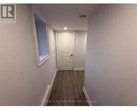 A hallway with a door and a window.