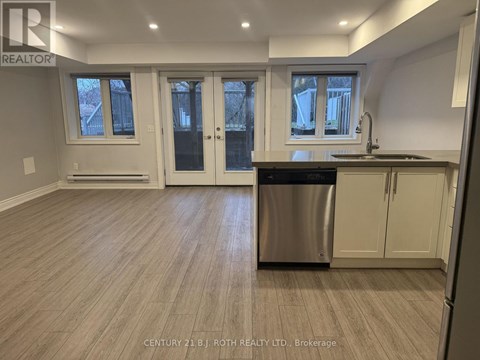 A kitchen with a dishwasher and cabinets.
