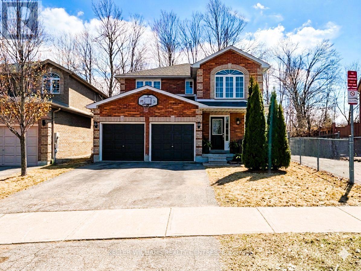 A brick house with a garage door and a driveway.