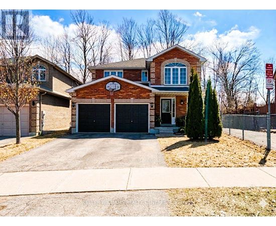 A brick house with a garage door and a driveway.