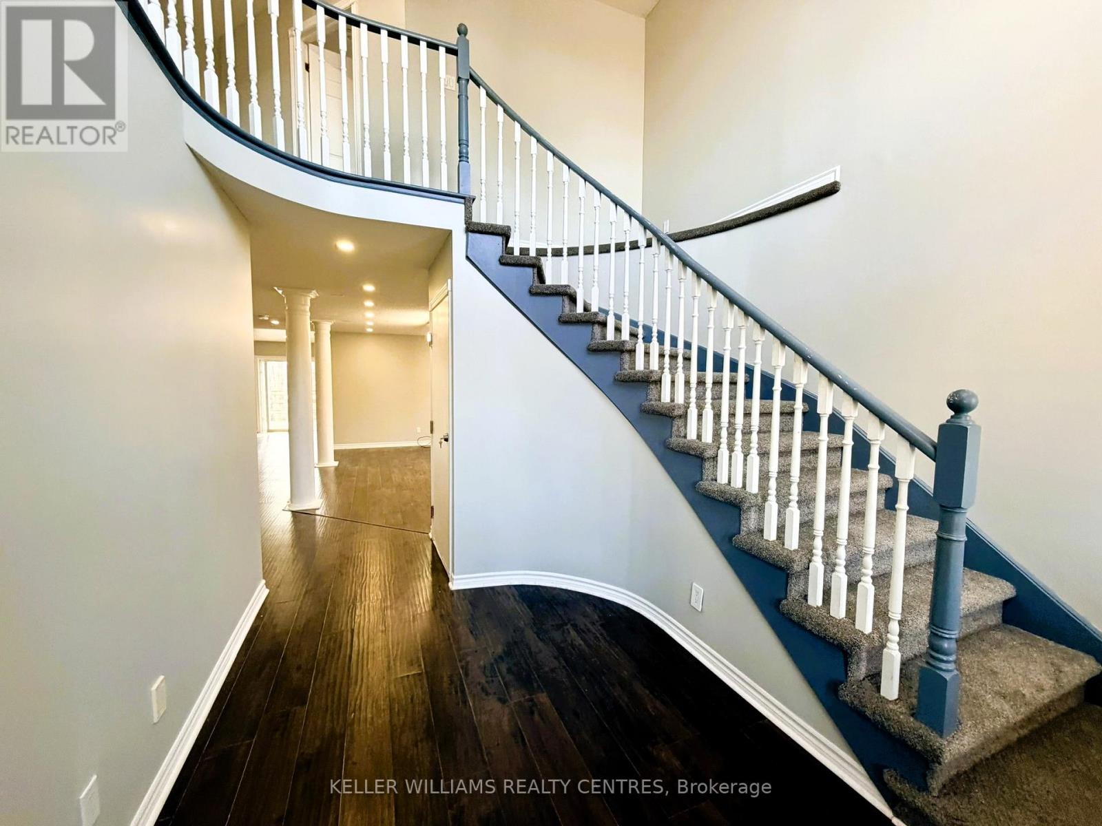 A staircase with a blue railing and wooden steps.
